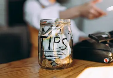 A glass jar with tips written on it.