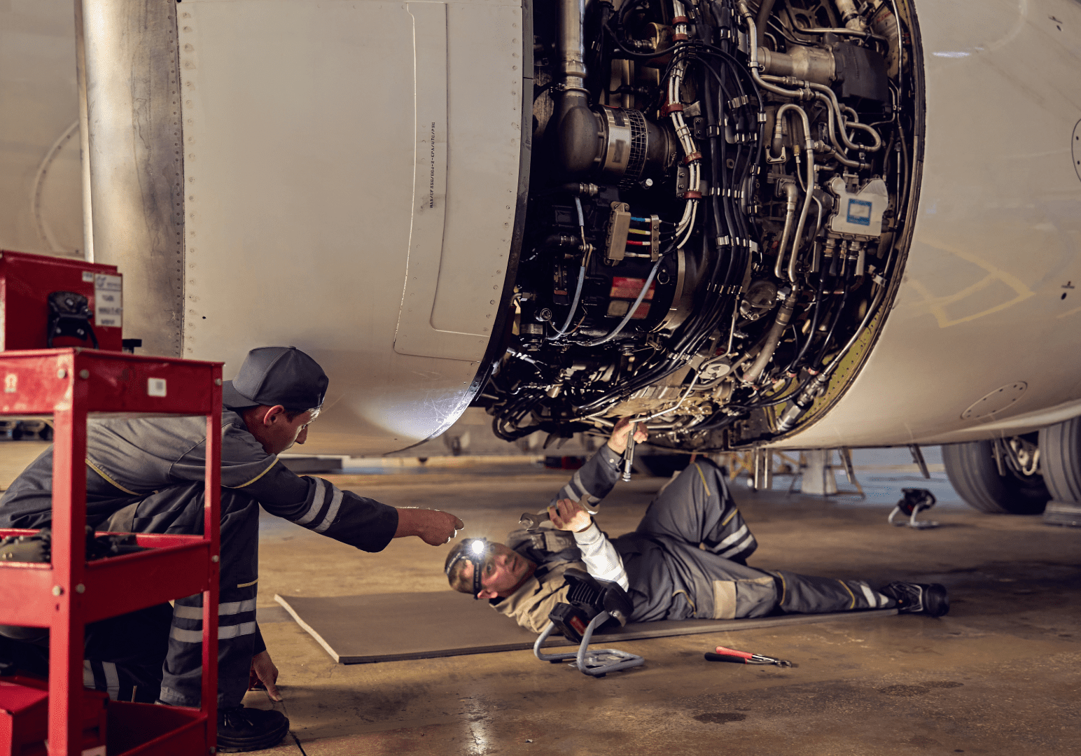 Aviation mechanic working on an airplane engine.