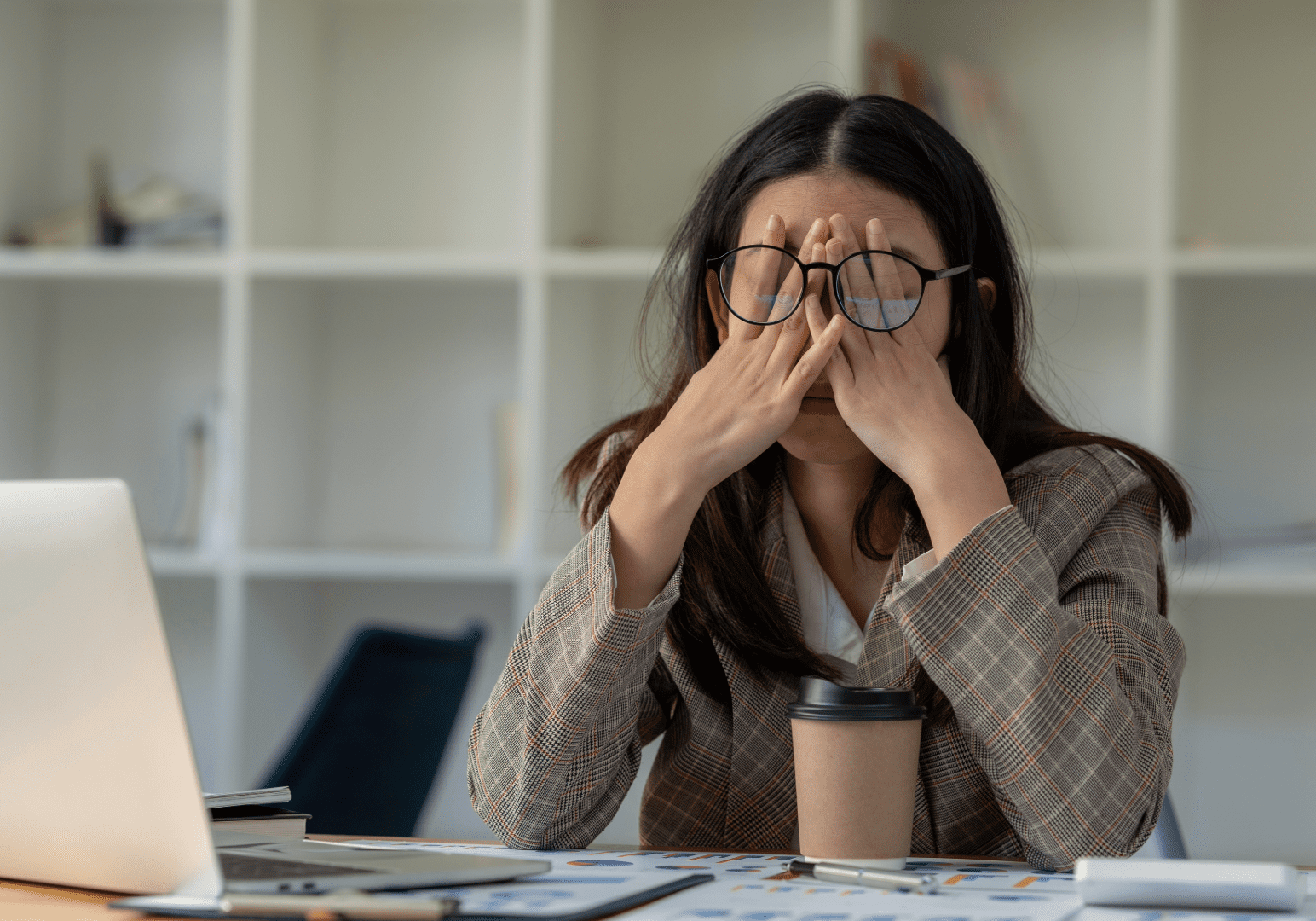 Remote staffed worker is at her desk tired from working overtime